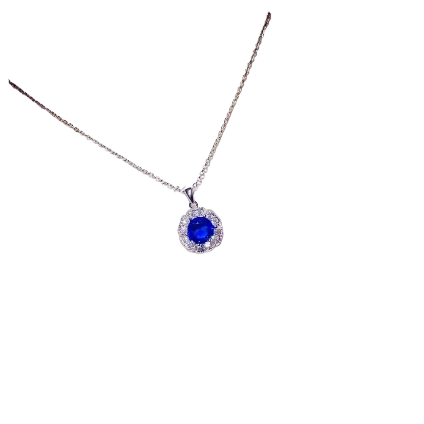 Delicate silver necklace pendant featuring a round blue created sapphire surrounded by clear stones fine jewelry