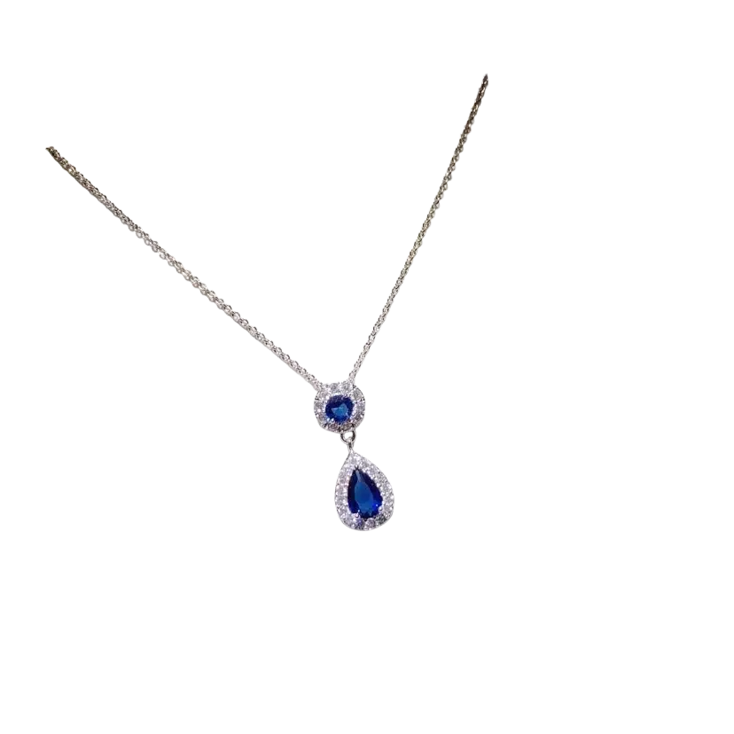 A delicate silver necklace pendant featuring a teardrop created sapphire surrounded by sparkling stones fine jewelry