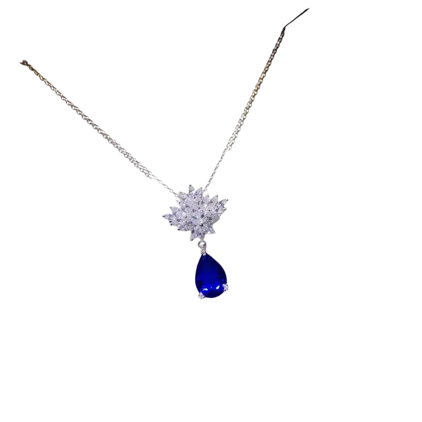 A sparkling silver necklace pendant with crystal floral design and created sapphire blue teardrop gemstone fine jewelry