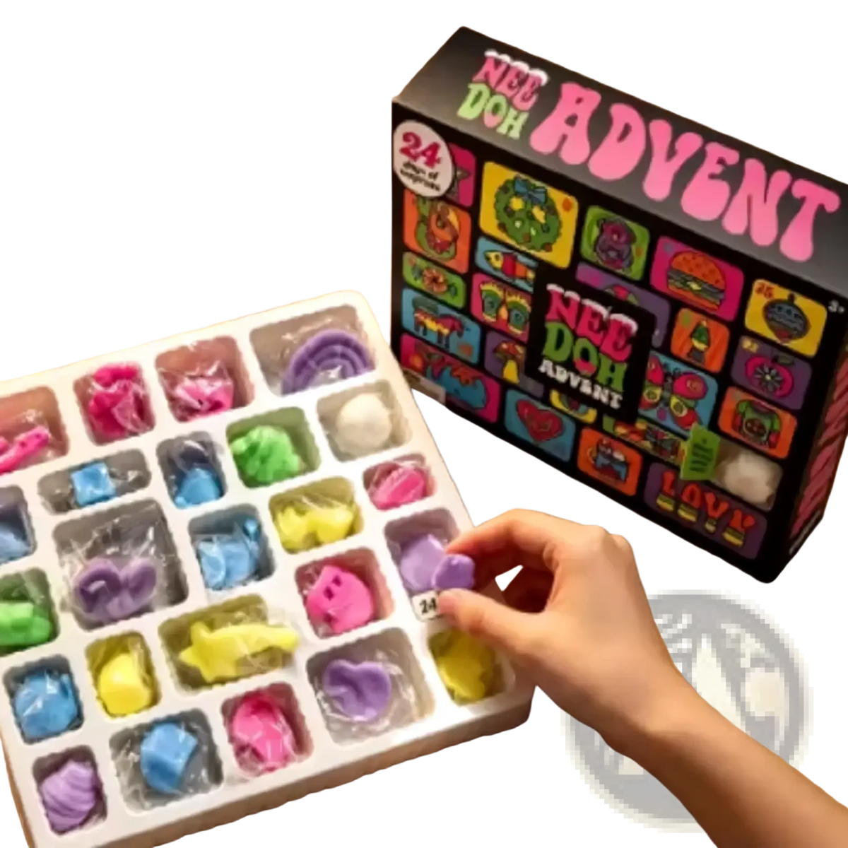 A hand reaches for a purple soft silicone nee doh charm from the Needoh Advent Calendar 24day sensory toy set