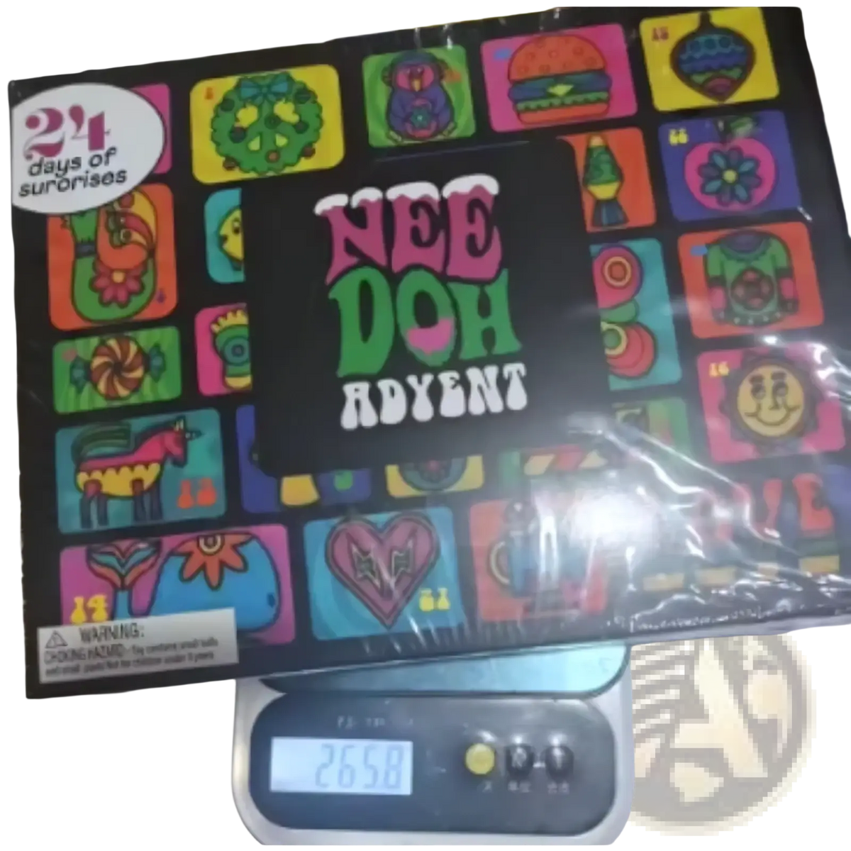 The needoh advent calendar 24-day sensory toy set box features a black surface with vibrant colorful cartoon illustrations