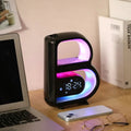 Black letter-shaped led smart b-shaped rgb bluetooth speaker and wireless charger with glowing purple and blue lights