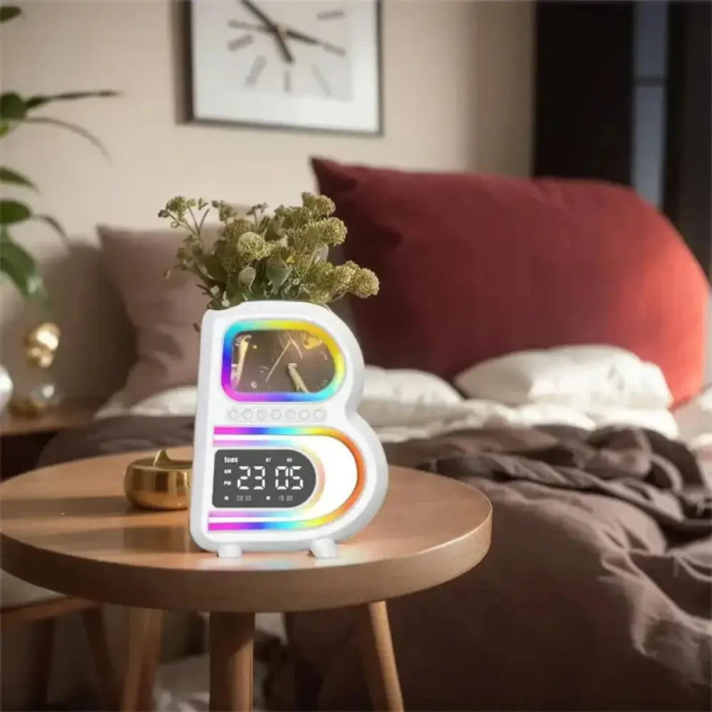 White letter-shaped smart b-shaped rgb bluetooth speaker and wireless charger with rainbow led clock display showing 23 05