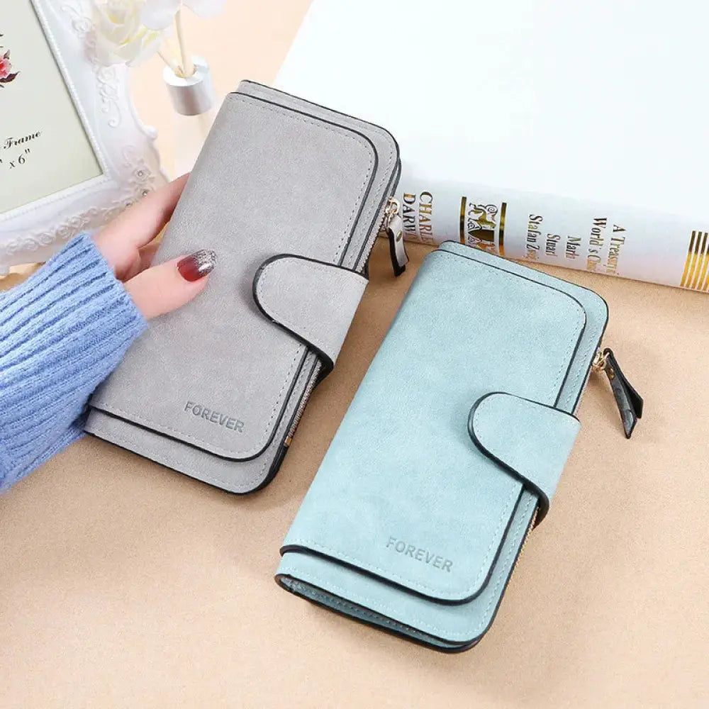 Women’s forever suede trifold buckle wallets in gray and light blue faux leather with black trim