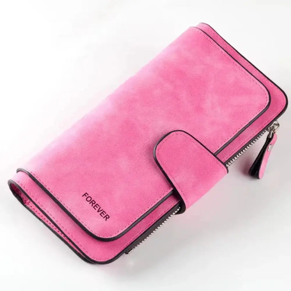 Pink suede women’s forever trifold buckle wallet with black stitching and zipper closure shown from the back side