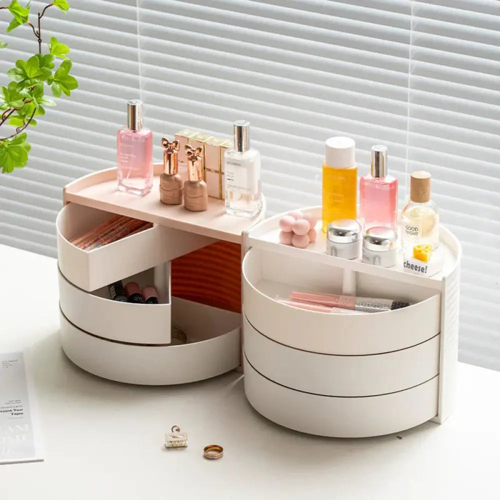 White multi-drawer circular makeup and jewelry organizer with a light wood top and 360 rotating tiered design