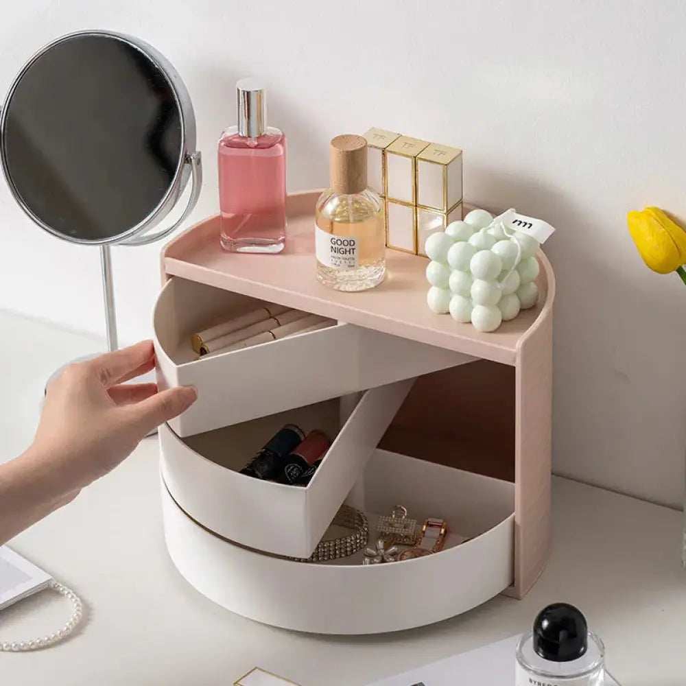 Pastel pink and white two-tier rotating makeup and jewelry organizer with a sleek modern design for storage