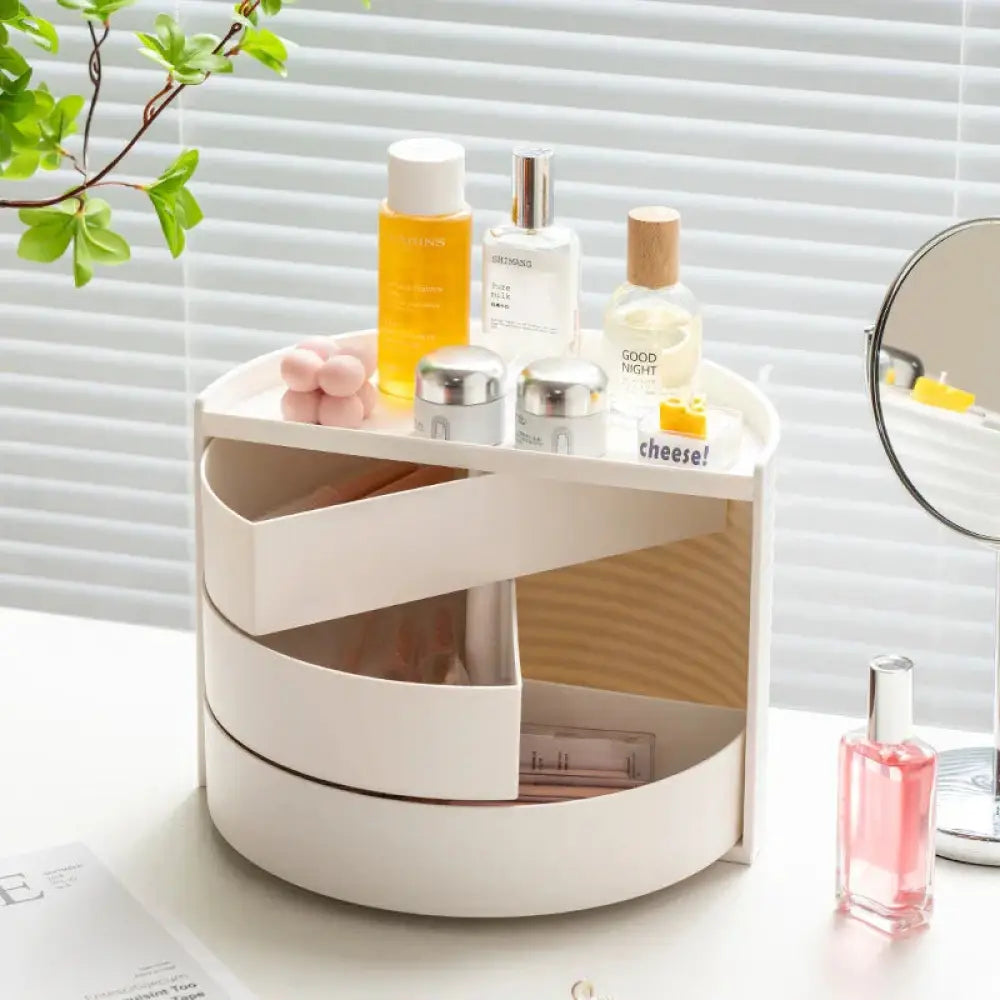 White multi-tiered rotating makeup and jewelry organizer with wooden interior accents for 360 degree access