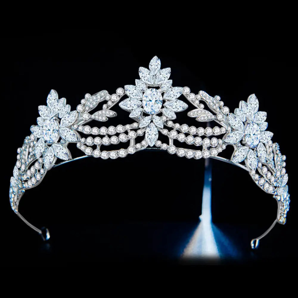 A silver floral bridal tiara with intricate designs and clear zirconia crystals for elegant wedding wear