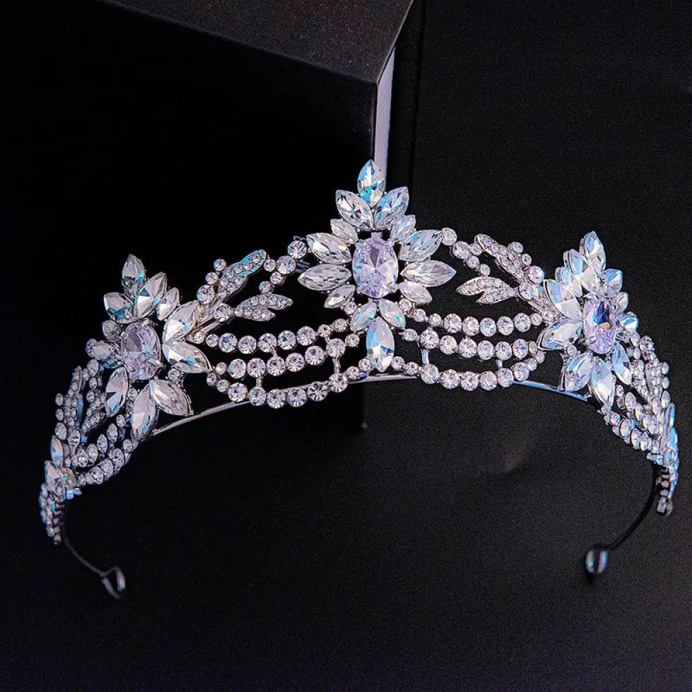 A silver bridal tiara with clear and light purple zirconia crystals in an intricate floral design