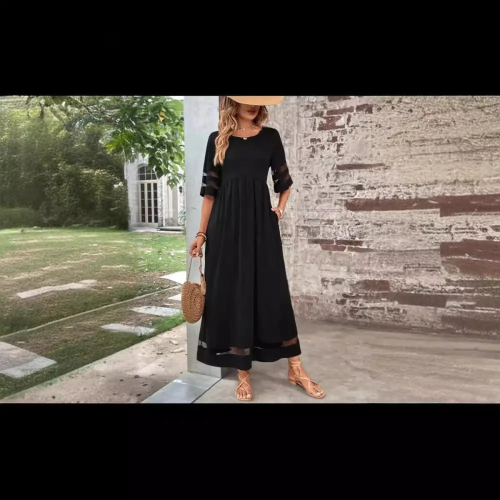 Black midi mesh patchwork maxi dress with sheer three quarter sleeve accents and flowing silhouette with pockets