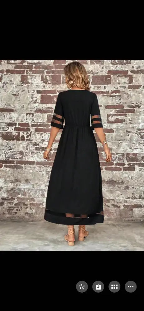 Black midi dress with sheer mesh panels at three-quarter sleeves and hemline featuring patchwork and pockets