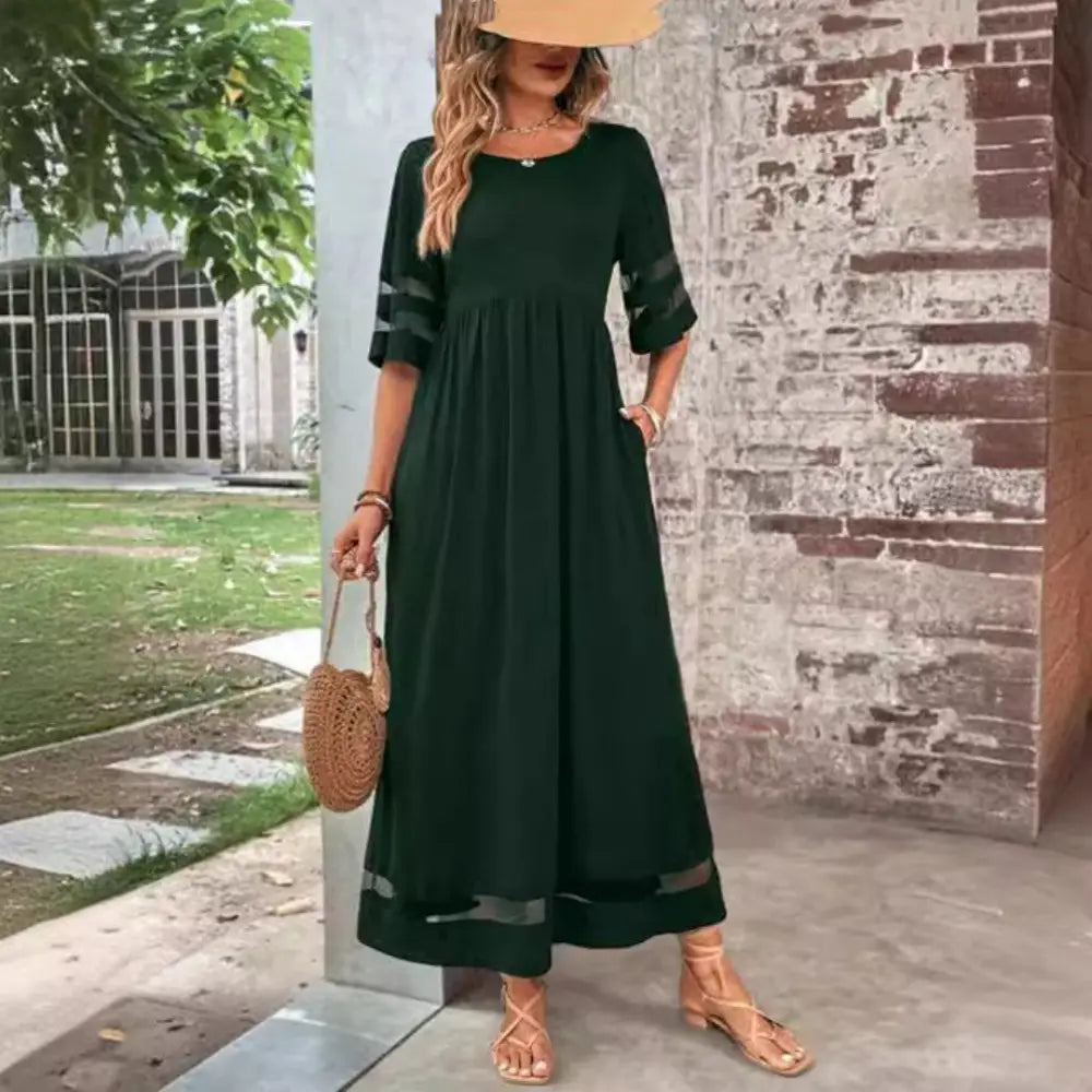 Dark green mesh patchwork midi dress with sheer mesh panels at sleeves and hem, featuring relaxed fit and three-quarter sleeves