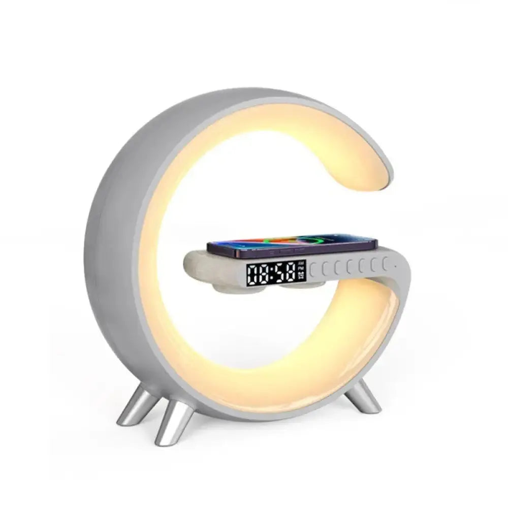 Modern gray crescent-shaped G-shape smart ambient light with digital clock Bluetooth speaker and wireless charging pad