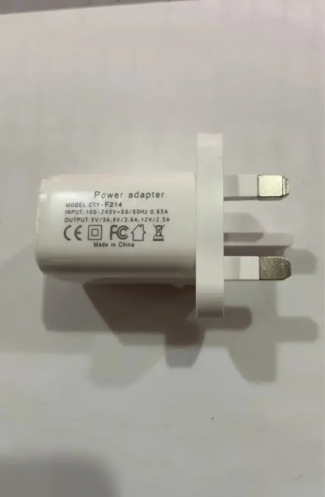 White plastic power adapter with three-prong uk plug and specifications for G-shaped led lamp with bluetooth speaker and charger