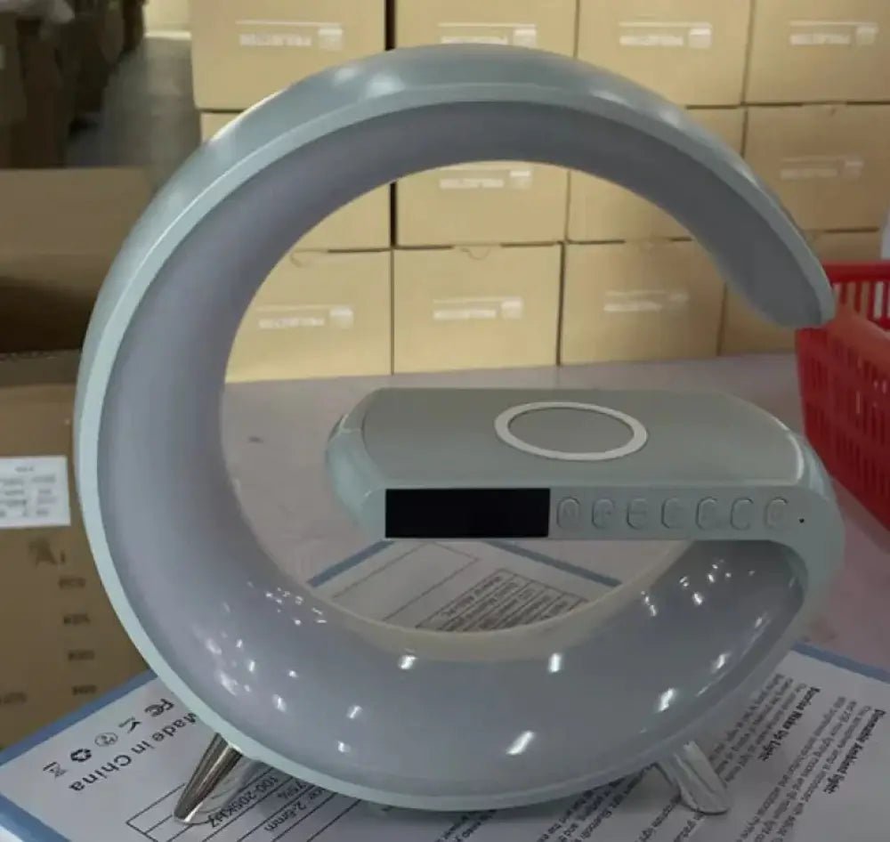 Light gray circular g-shape smart ambient desk lamp with bluetooth speaker and charger featuring a sleek modern design