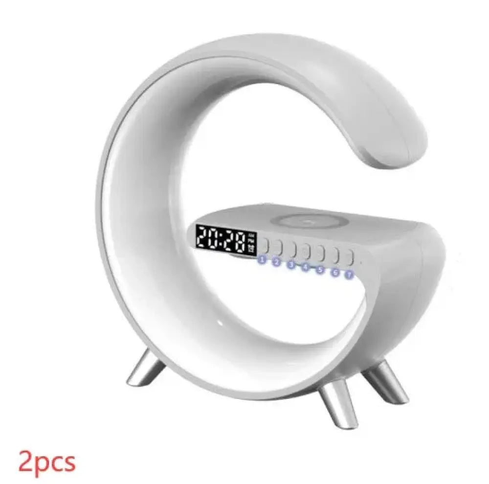 White sleek c-shaped digital g-shaped led lamp with glowing display metallic legs bluetooth speaker and wireless charger