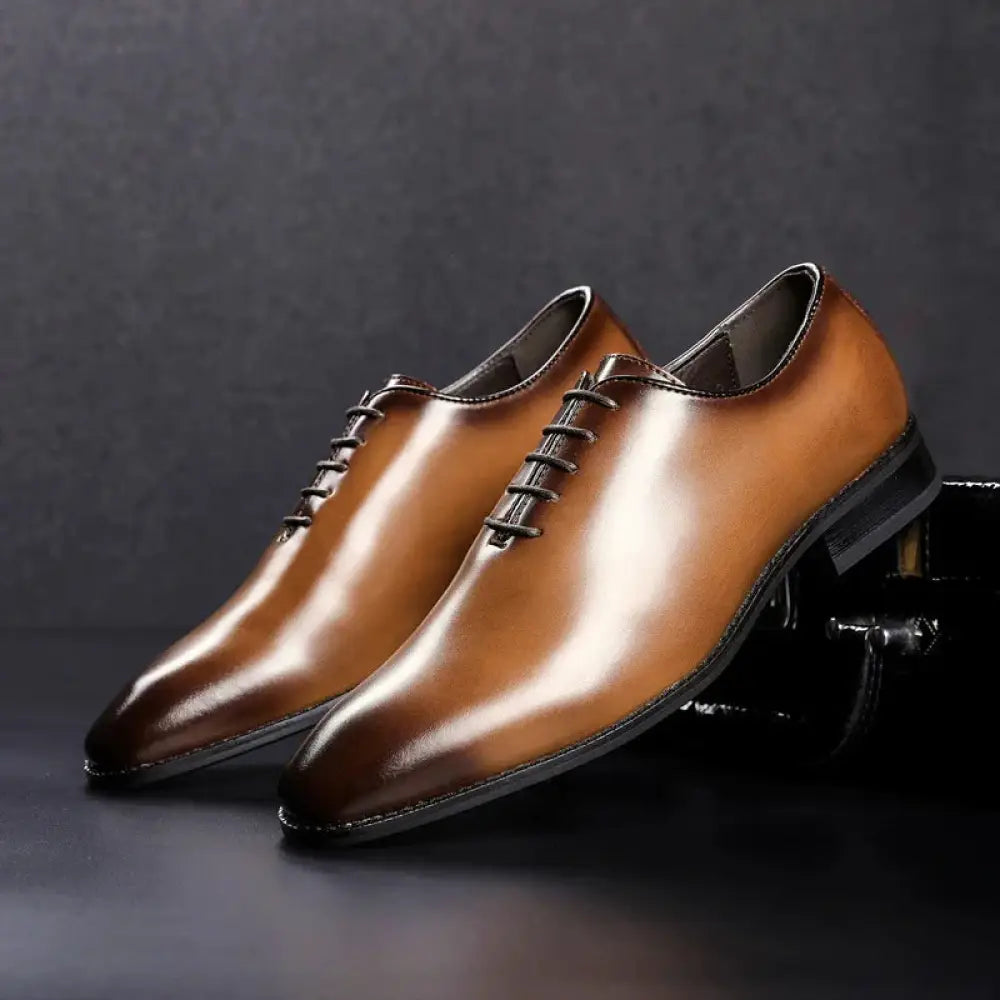 Hand-polished leather business oxford shoes in polished tan with black laces and a sleek pointed toe design