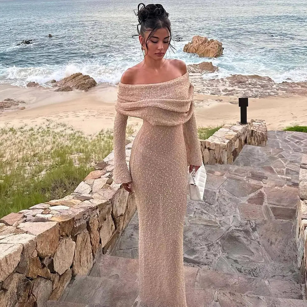 Shimmering champagne-colored long-sleeved off-the-shoulder gown with a fitted silhouette and textured fabric