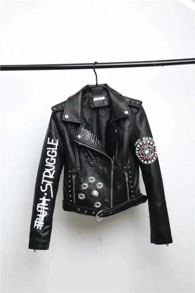 Black faux leather biker jacket with white studded details and embroidered patches including struggle and star emblem
