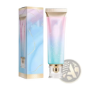 A gradient-hued iridescent tube of niacinamide brightening toothpaste with a gold cap and clear base for fresh breath 100g