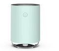 A sleek mint green modern 3-in-1 led night light and essential oil diffuser with a clear glass base and front power button