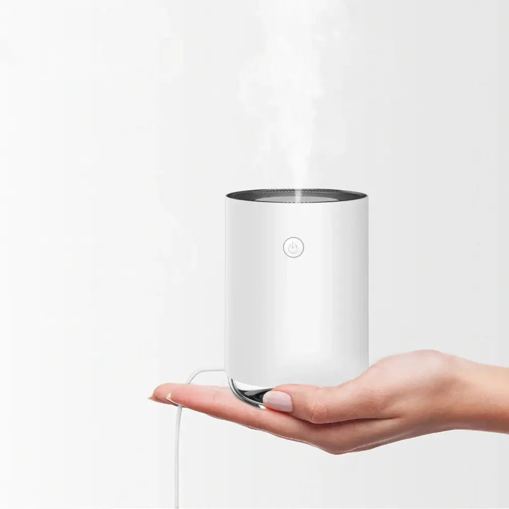 White cylindrical modern 3-in-1 led night light and essential oil diffuser with silver accents and minimalist design