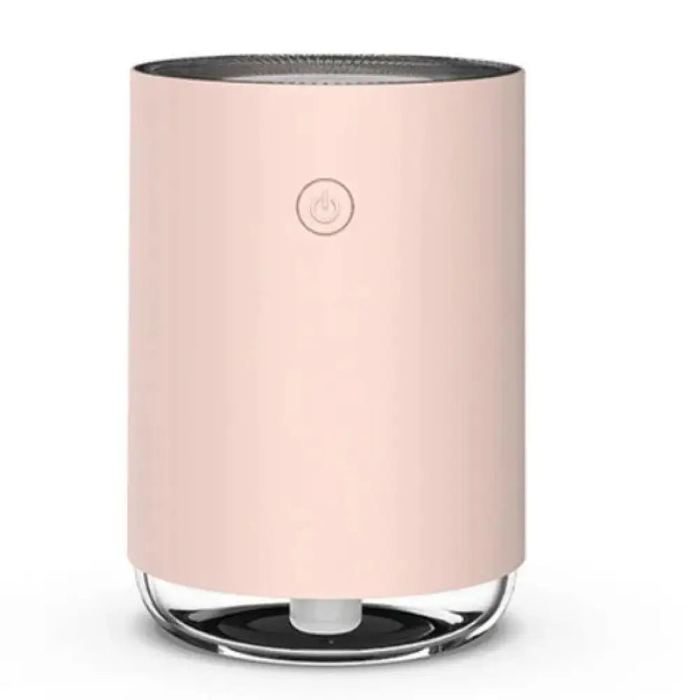 A sleek blush pink cylindrical modern 3-in-1 led night light and essential oil diffuser with a clear glass base