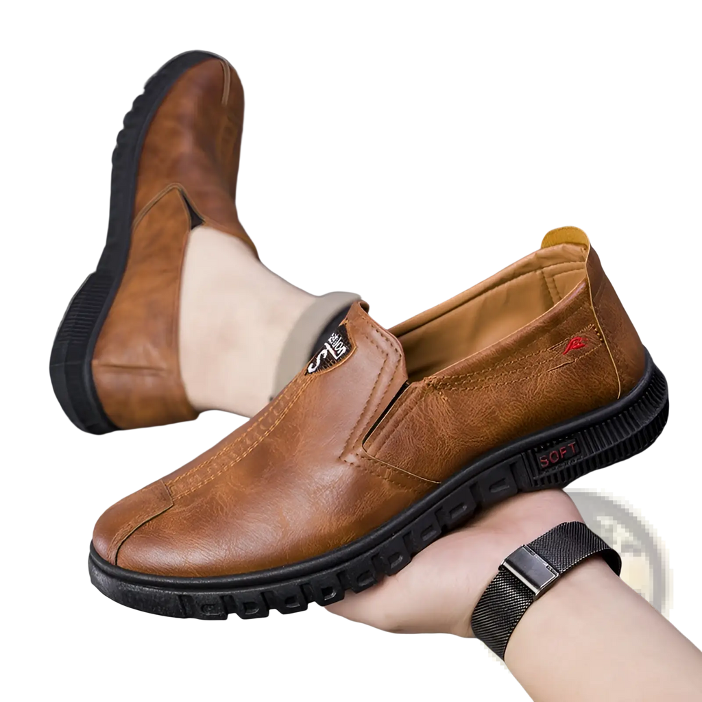 Brown leather slip-on non-slip chef loafer with black rubber sole and soft branding on the heel viewed from the back