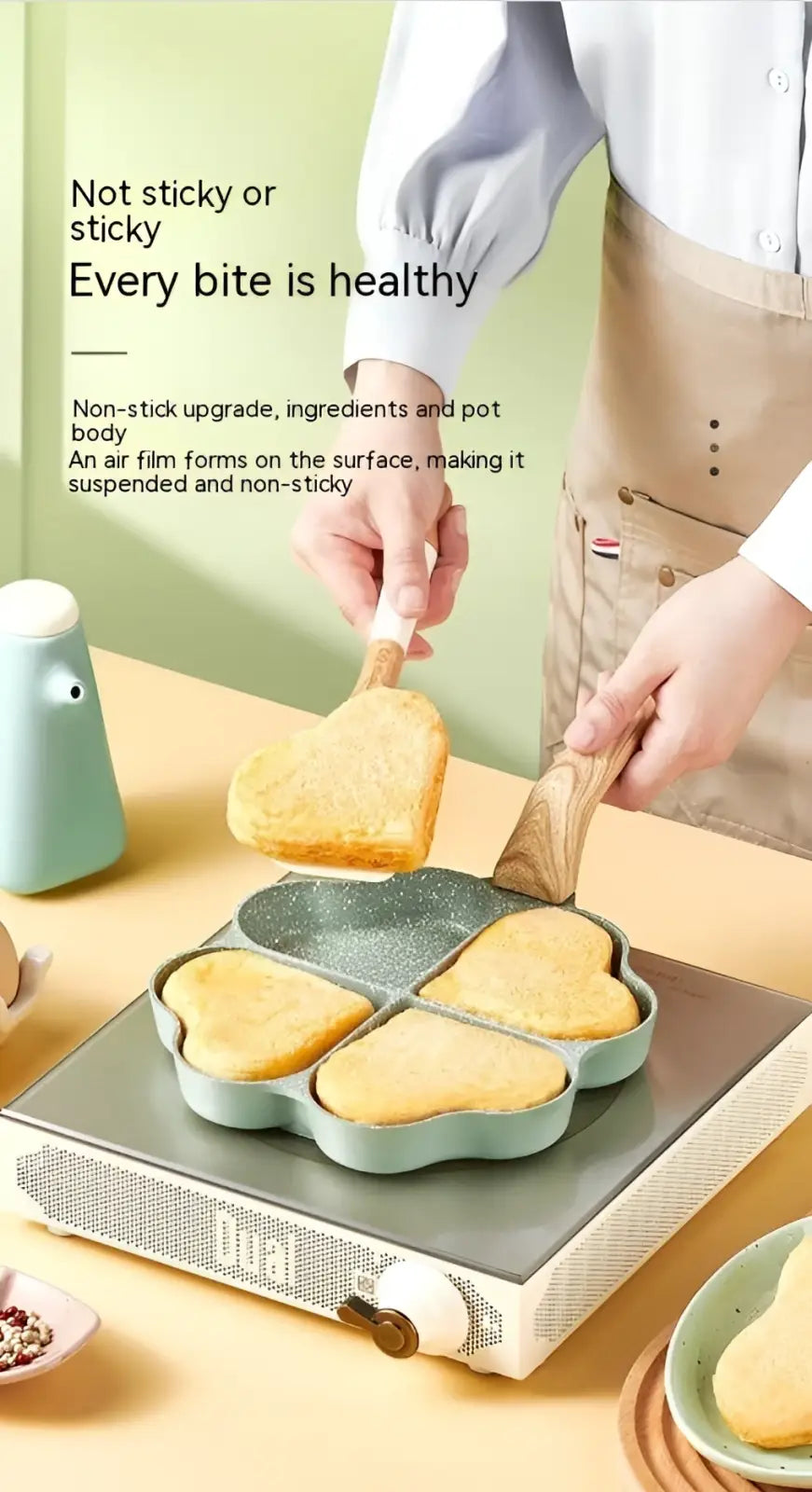 Light green heart-shaped nonstick four hole egg frying pan with wood handle for easy cooking