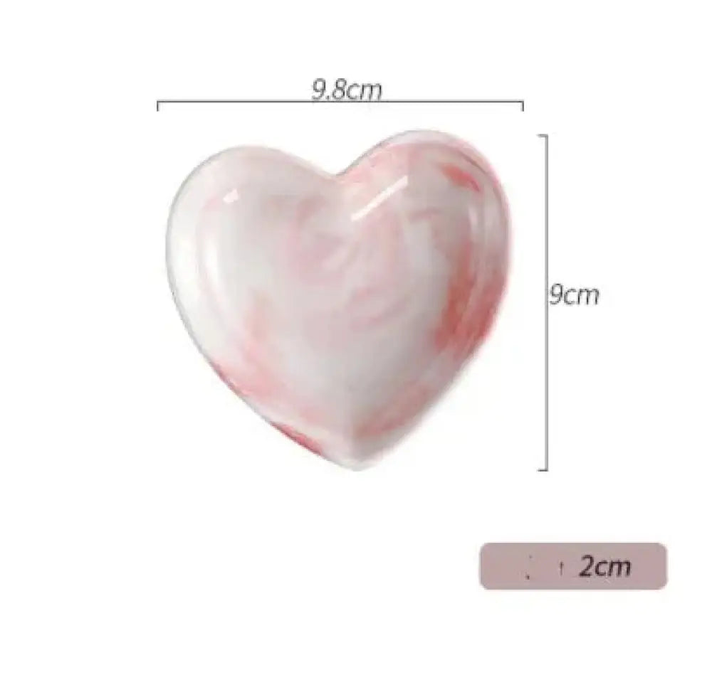 A glossy heart-shaped ceramic dish with soft pink and white marbled pattern from nordic marbled heart dinnerware set