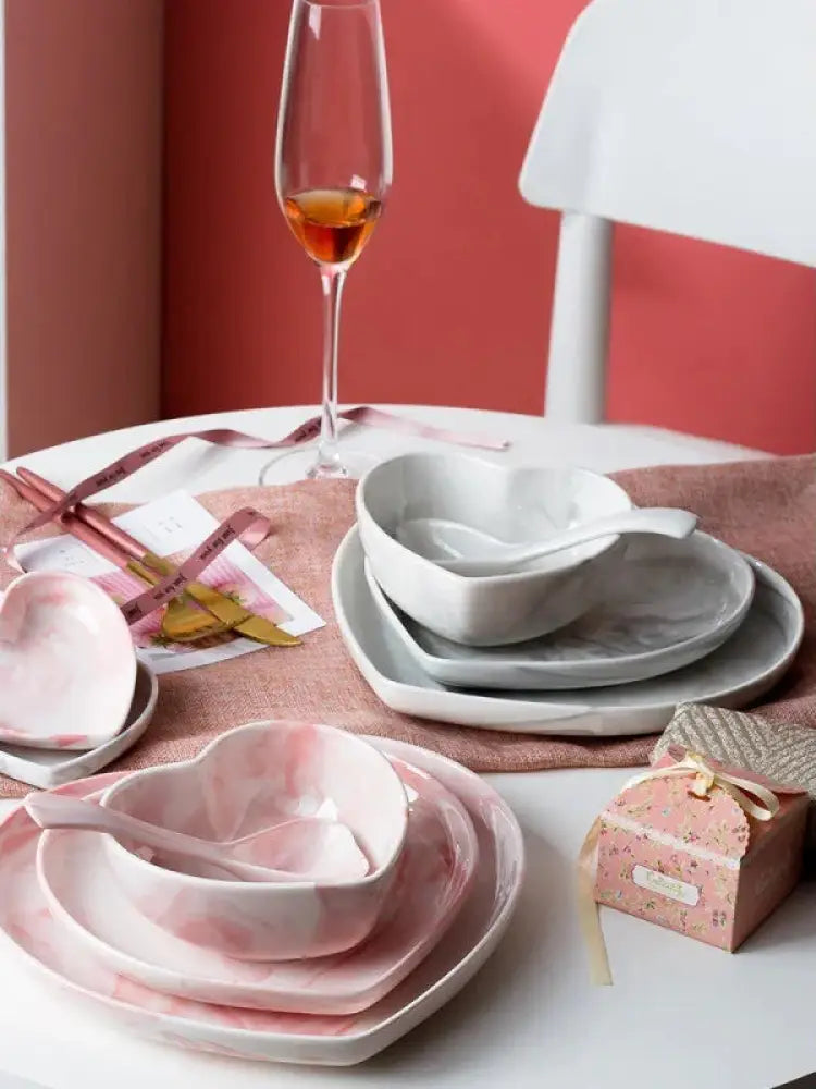 Pink and white ceramic heart-shaped bowls with matching spoons in nordic marbled heart ceramic dinnerware set
