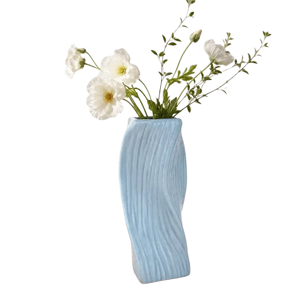 A light blue ceramic Nordic wave vase with a sleek wavy design and vertical ridges for aesthetic home decor