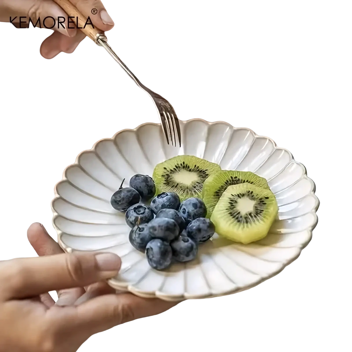 A delicate off-white nordic white ceramic scalloped dinner plate featuring the kemorela brand name