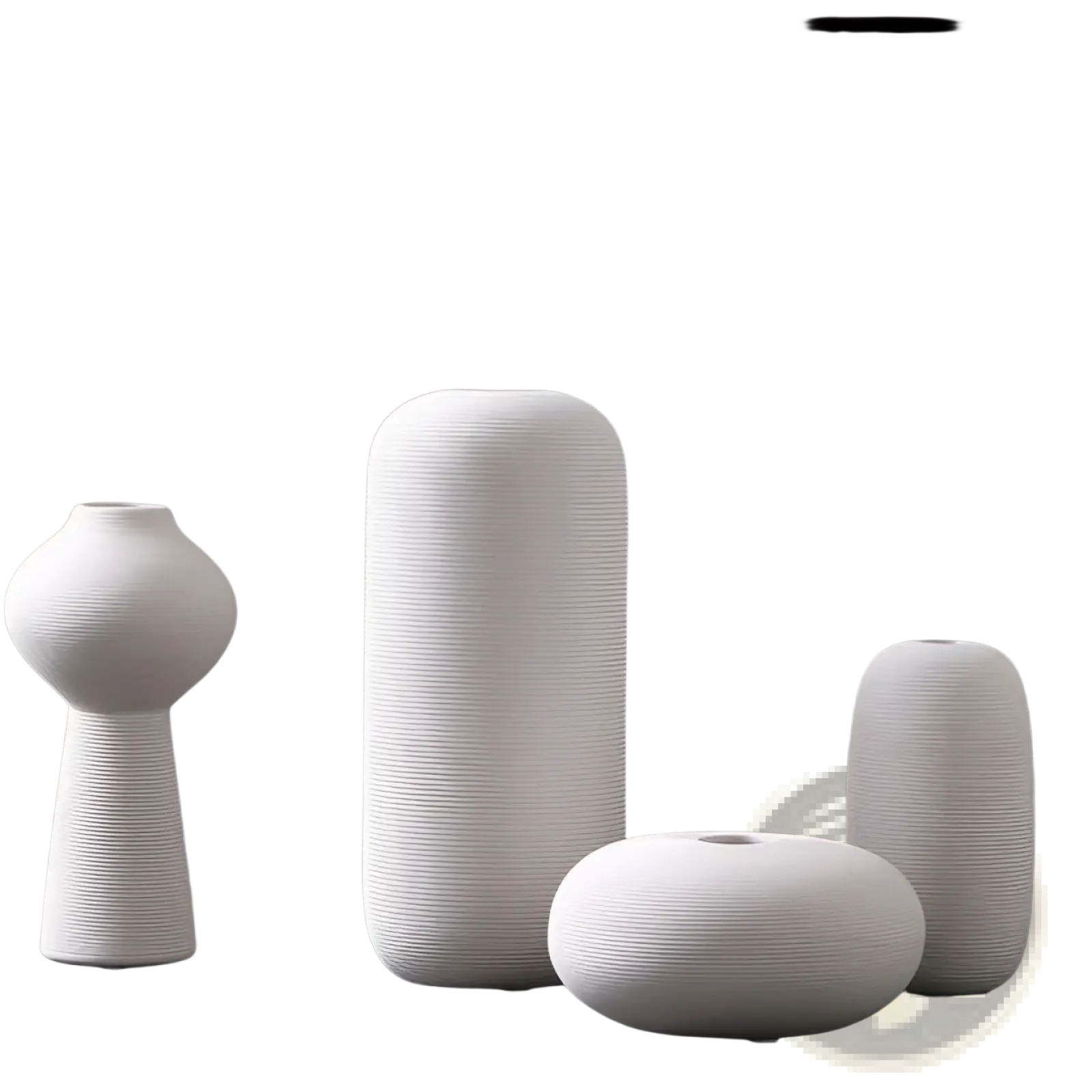 Set of four minimalist white ribbed ceramic vases with textured surfaces for modern home decor