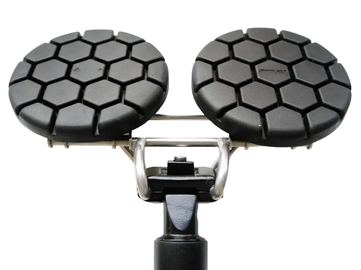 Black hexagonal-patterned rubber pads on a metallic frame with a cylindrical base for noseless ergonomic long distance bicycle saddle