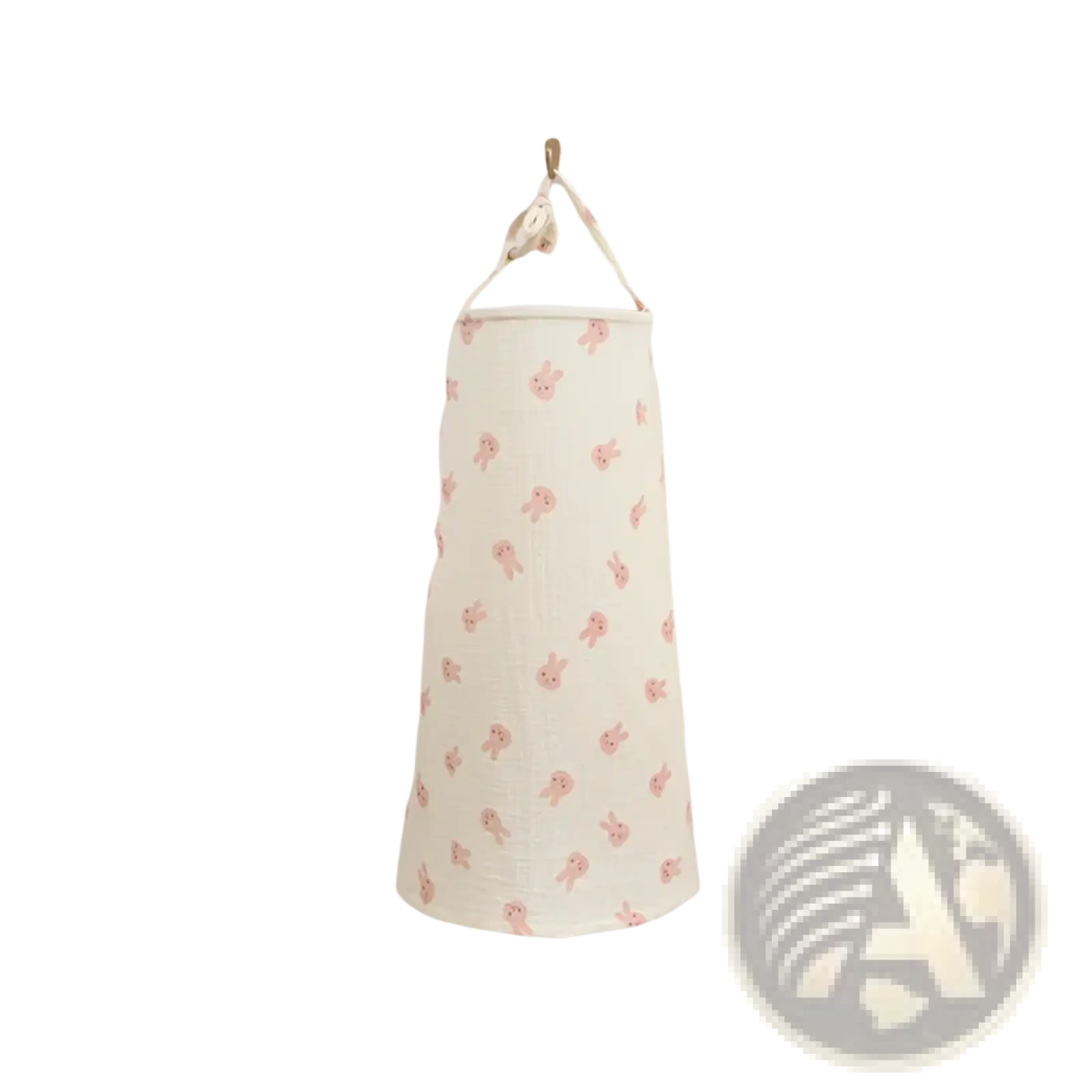 A cream cotton laundry hamper with pink bunny pattern hanging on wall paired with a breathable nursing cover dinosaur print