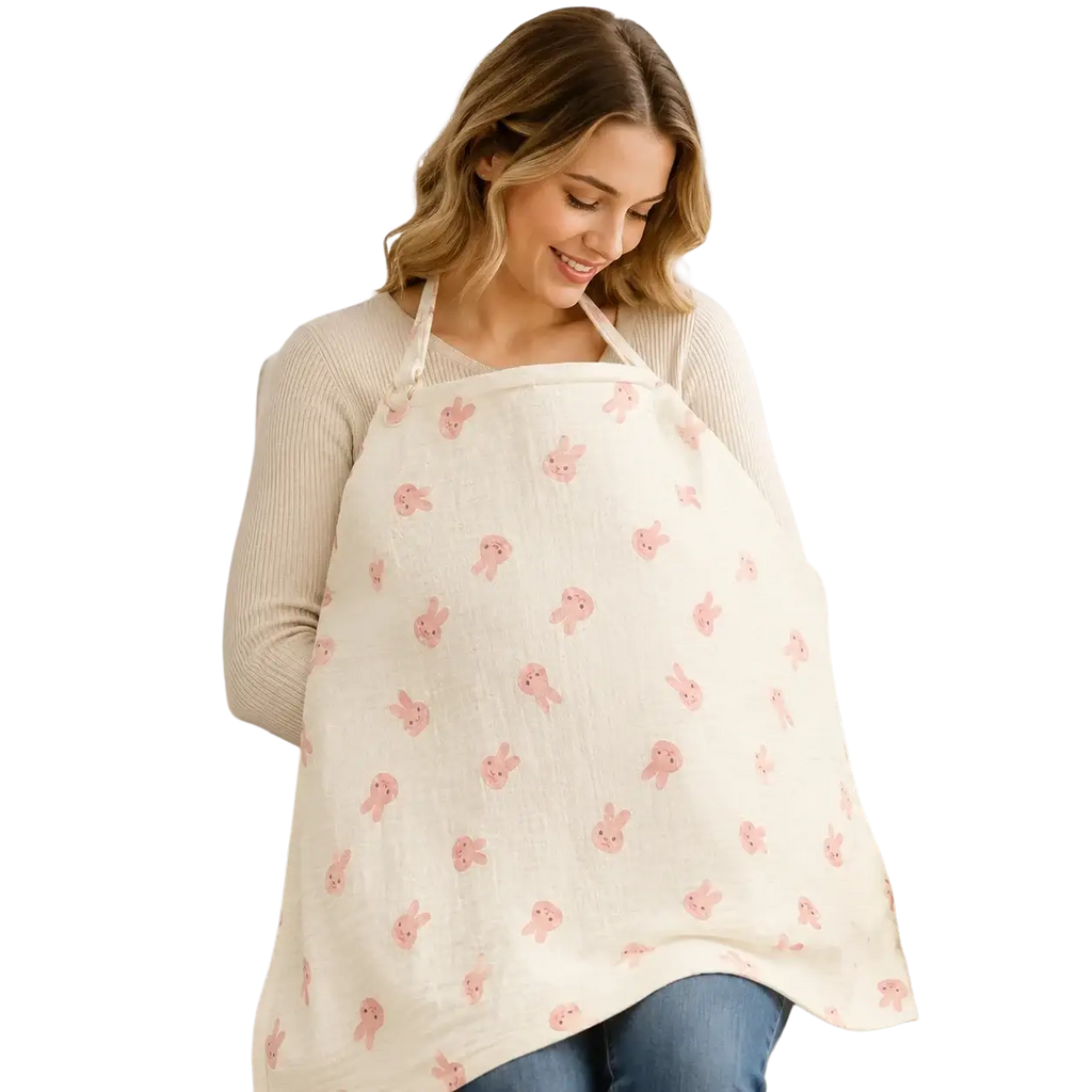A soft off-white cotton nursing cover with a breathable fabric featuring a gentle pattern of pink cartoon bunnies