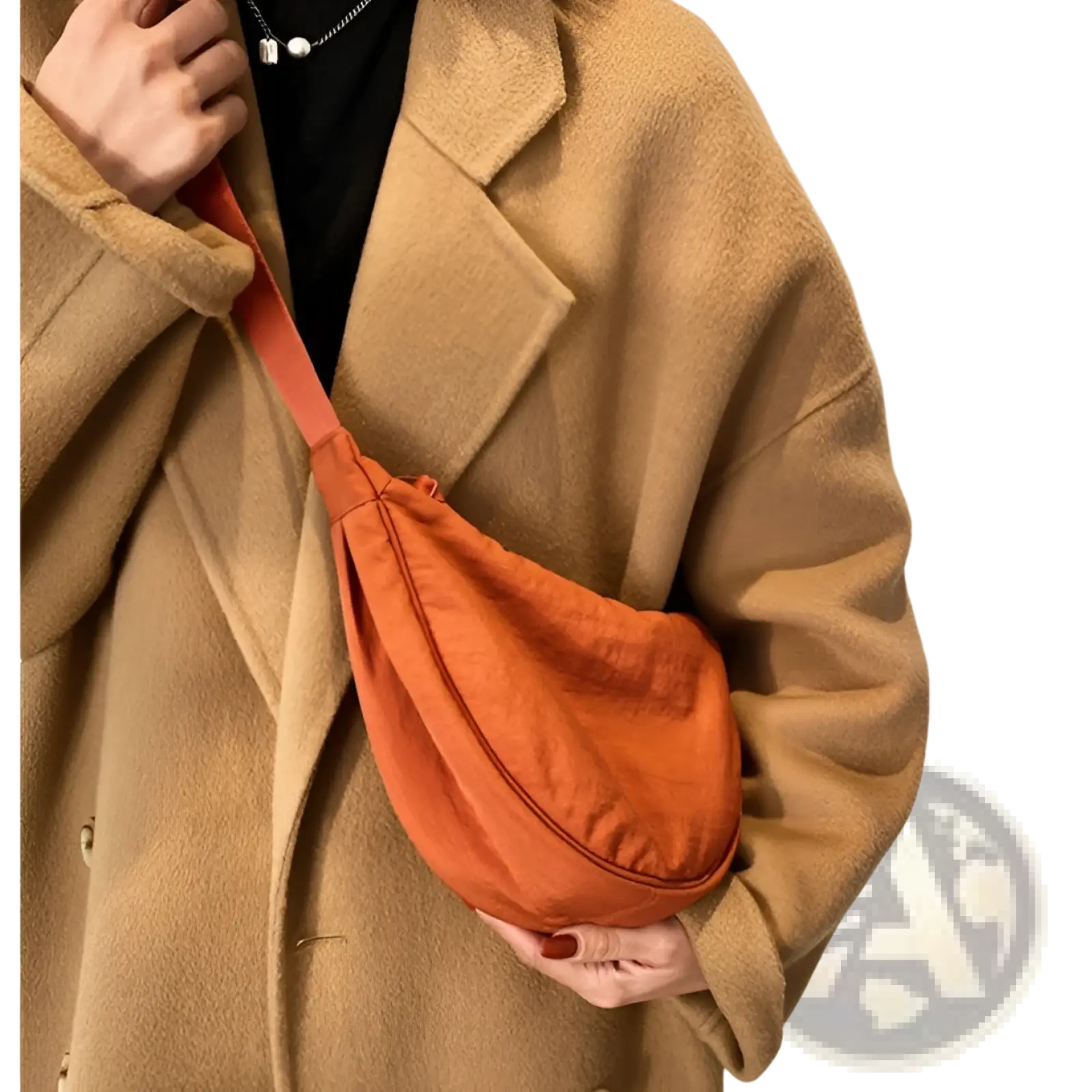 Orange nylon dumpling messenger bag with curved canvas crossbody strap designed for convenient daily use