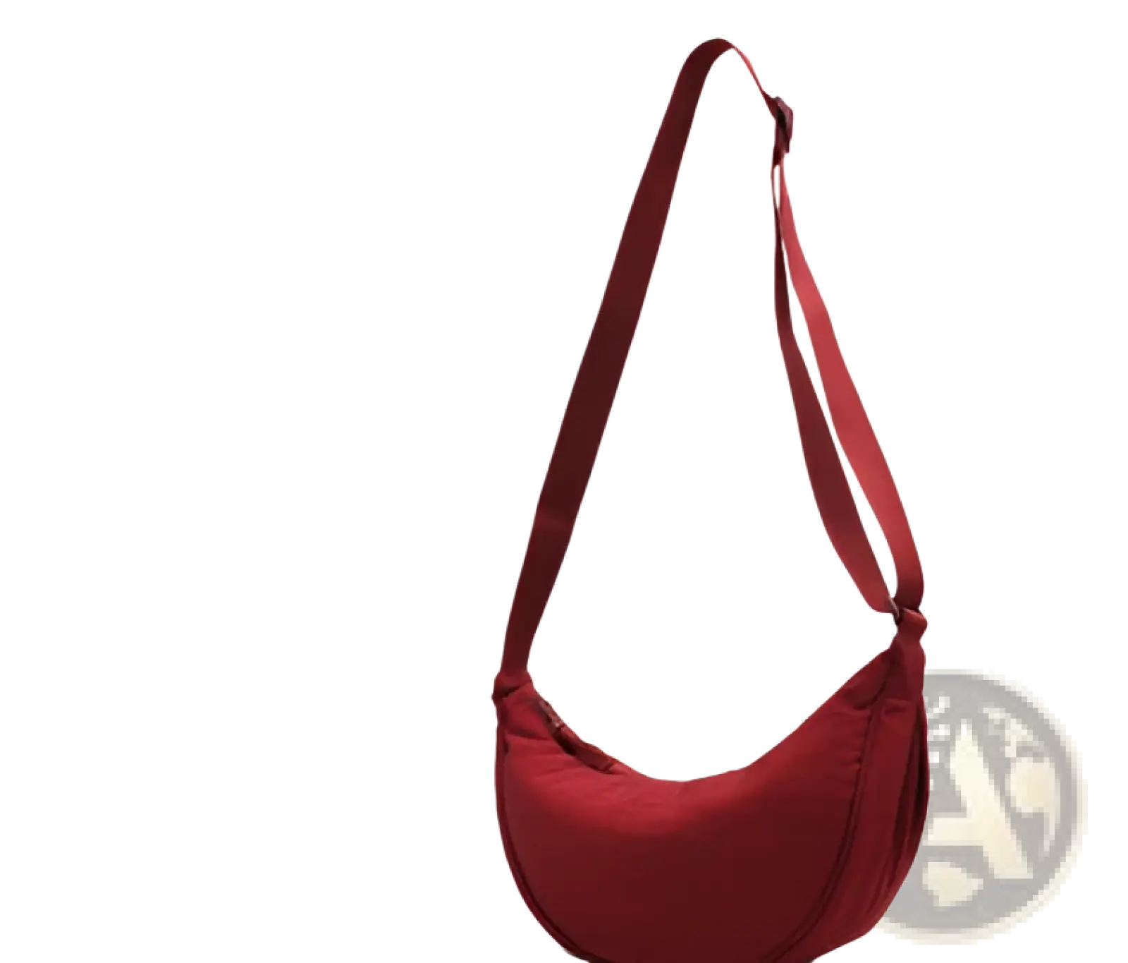 A sleek deep red nylon dumpling messenger bag with a curved minimalist design and adjustable crossbody strap
