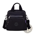 Black nylon messenger bag with silver zippers and circular logo patch featuring multiple zipper compartments