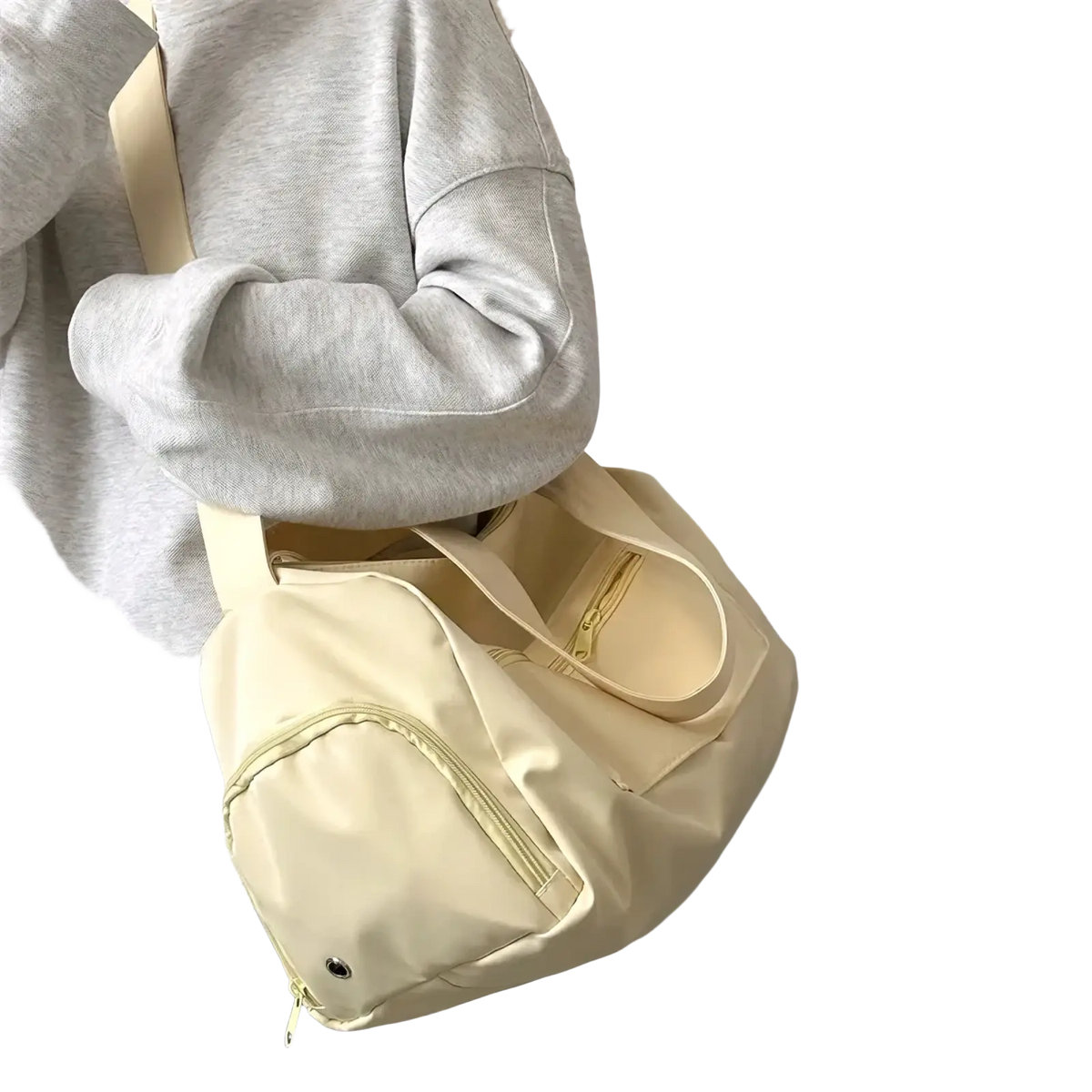Cream-colored nylon travel tote bag with matching strap and front zipper pocket for casual shoulder use