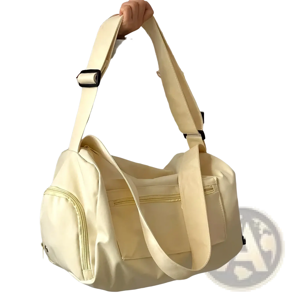 Cream-colored nylon travel tote bag with adjustable canvas shoulder strap and multiple zippered compartments for casual use