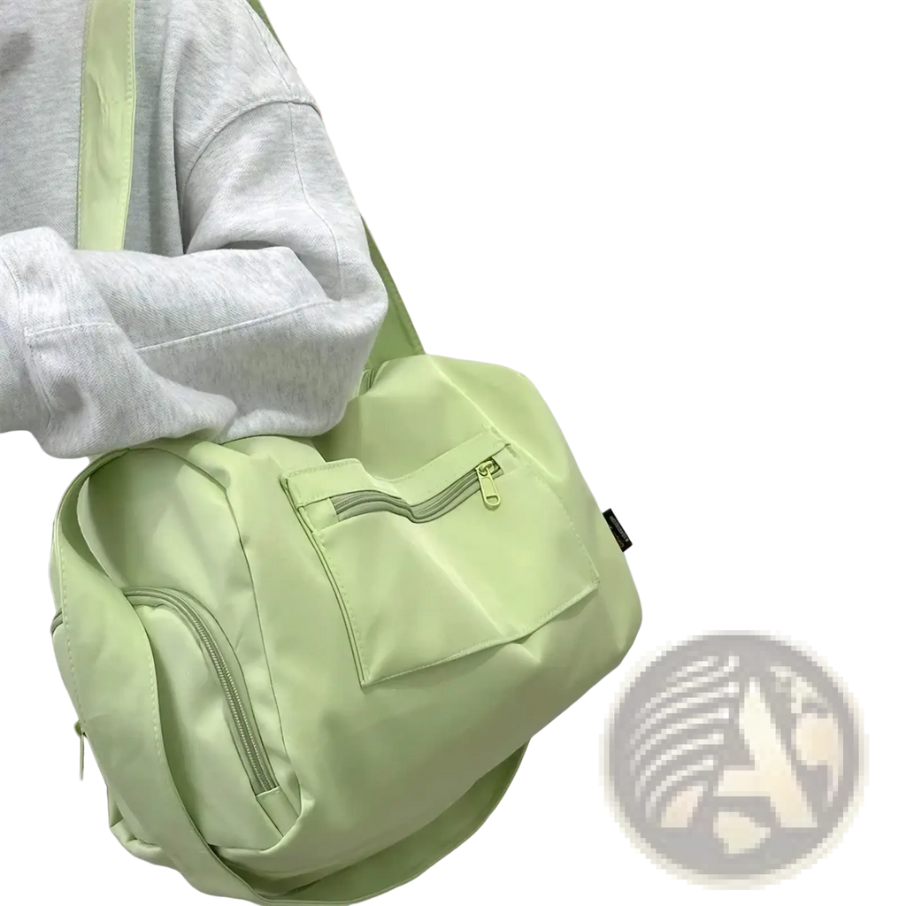 Light green nylon travel tote bag with front zippered pocket and matching strap for casual shoulder use