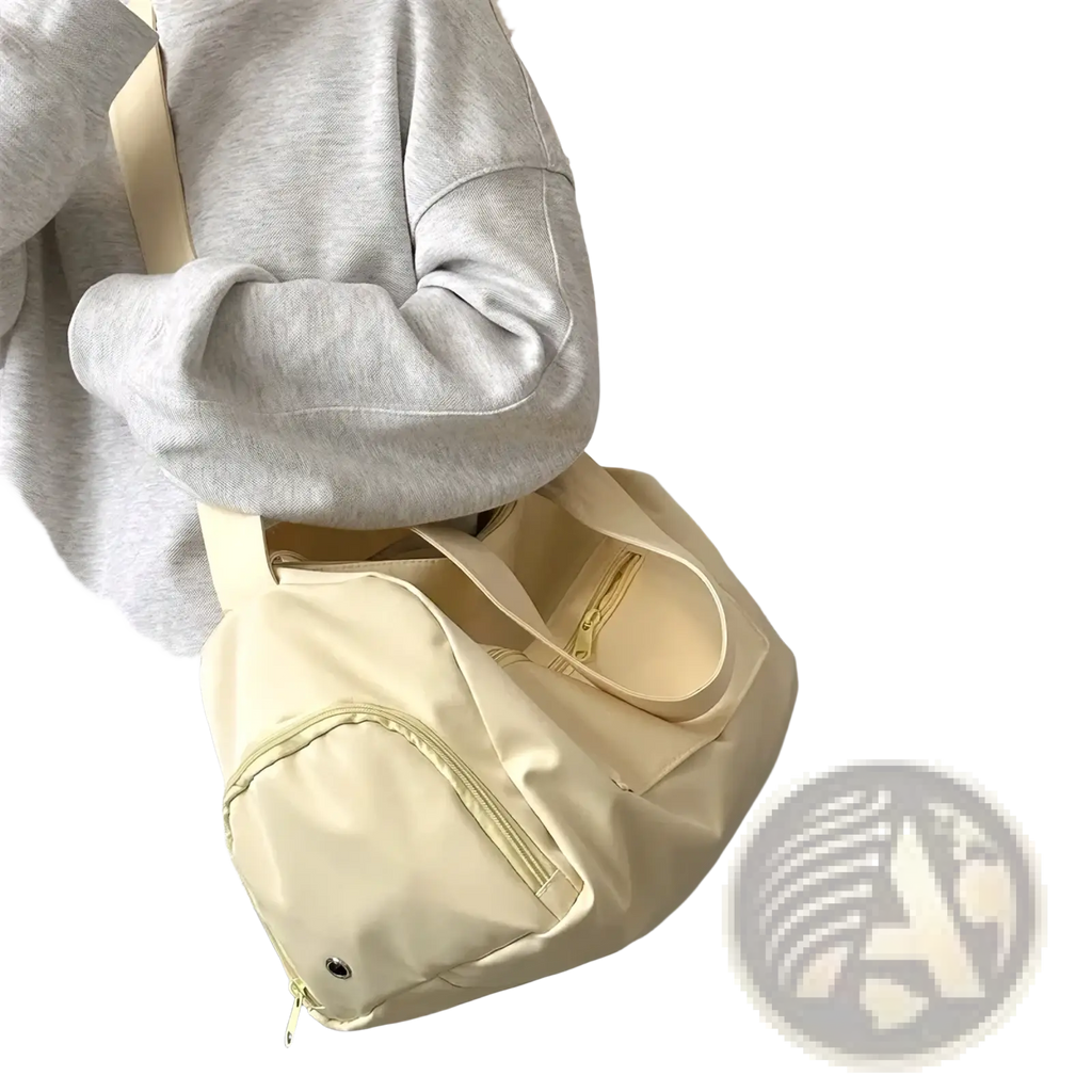 Cream-colored nylon travel tote bag with matching strap and front zipper pocket for casual shoulder use