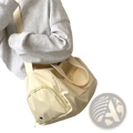 Cream-colored nylon travel tote bag with matching strap and front zipper pocket for casual shoulder use