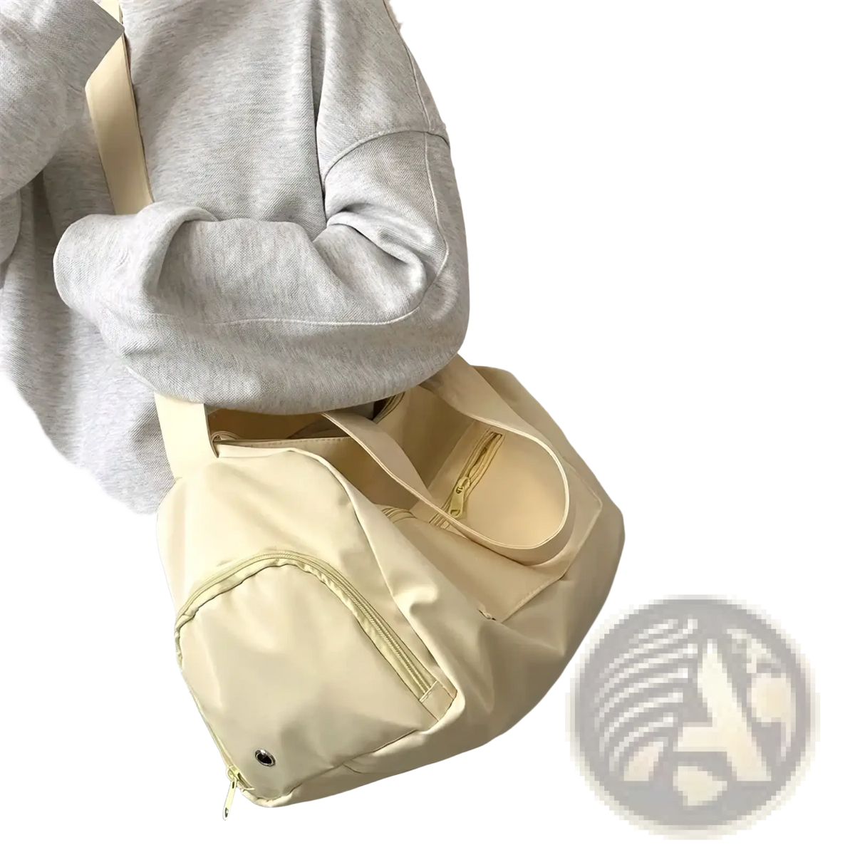 Cream-colored nylon travel tote bag with matching strap and front zipper pocket for casual shoulder use