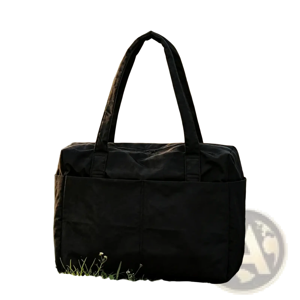 Black nylon travel tote bag with large capacity, sturdy handles, and a zippered front pocket for convenient storage