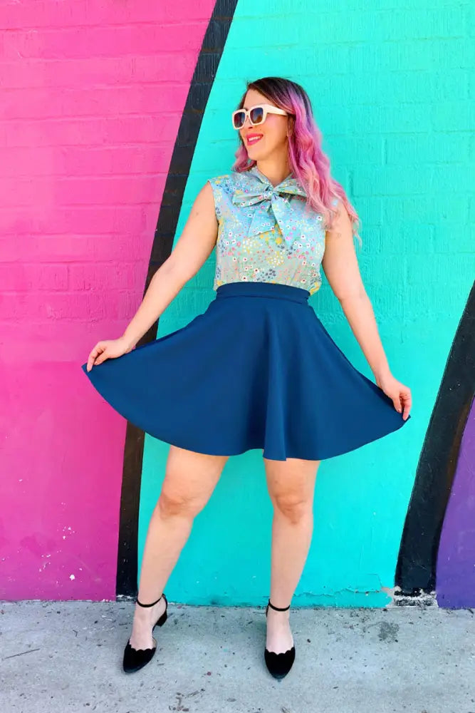 Ocean blue high waisted pleated skater skirt in navy blue with a flared silhouette and functional pockets
