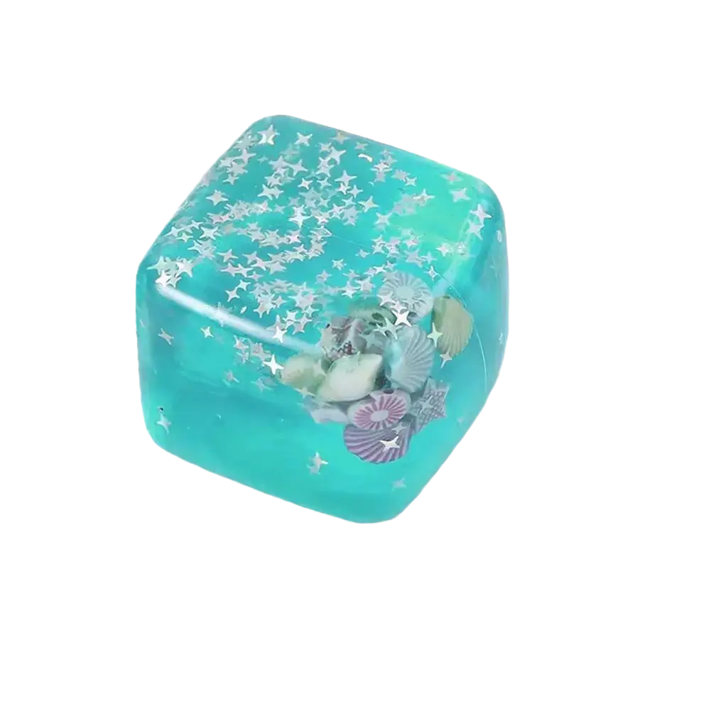 A turquoise resin sensory fidget cube filled with seashells and silver stars perfect thoughtful gift